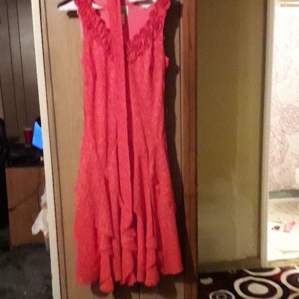 Dress swings at the bottom has a sash belt no slee